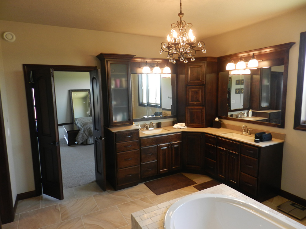 Impact Construction | Hull Iowa | Sioux County Construction near me | Building a house | Interior Design | Updated Bathroom | Bathtub spa with tiling | Double sink with wood cabinets